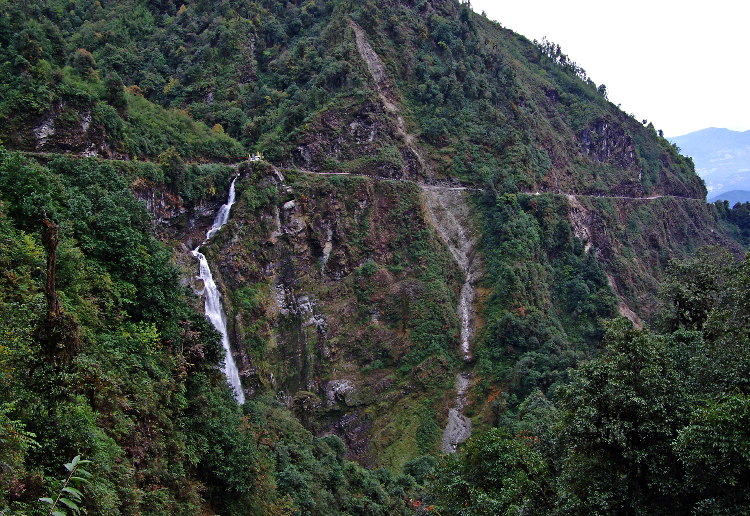 Many roadsd in Bhutan are cut out of ledges along the sides of steep valleys