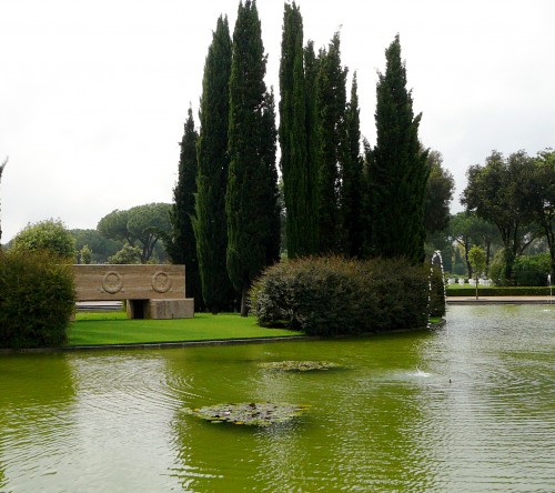 The pool surround a island of cypress and a cenotaph