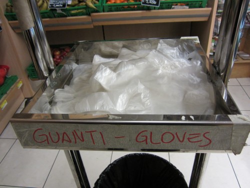 Glove up before selecting produce at an Italian supermarket