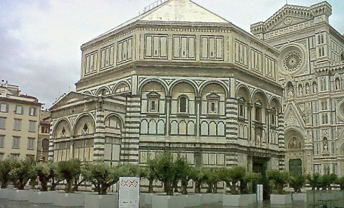 Dwarfed by the Baptistry and Duomo the forest of olive trees are obscure the people