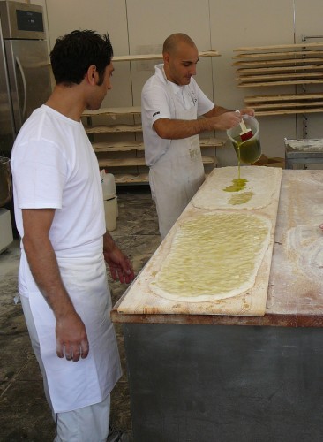 Making schiacciata with fresh Tuscan olive oil