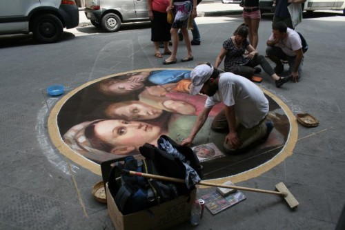 Kelly and another street artist put the finishing touches on Raphael's Madonna of the Chair